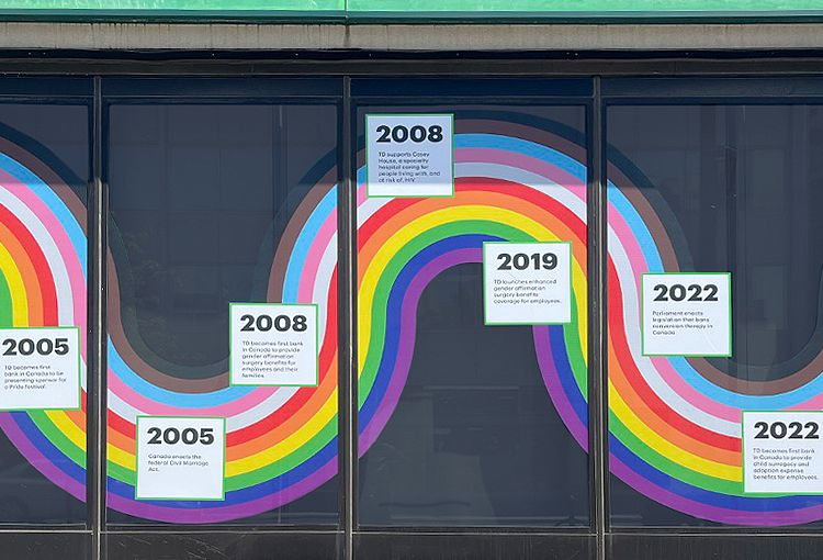 The window of a TD branch is decorated with a large rainbow themed graphic celebrating 2SLGBTQ+ history.