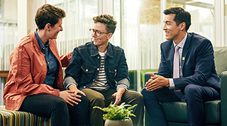 A TD colleague meets with a same-sex couple in a branch office to discuss their finances.