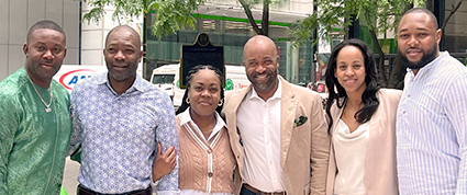 A group of TD Regional Managers stand together outside of an office. 