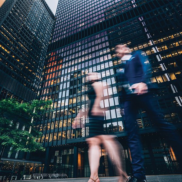 Woman and man walking in front of the TD office tower