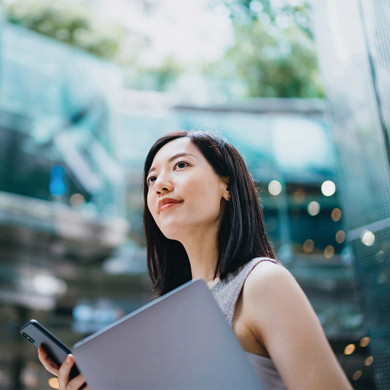 Woman with laptop and cell phone