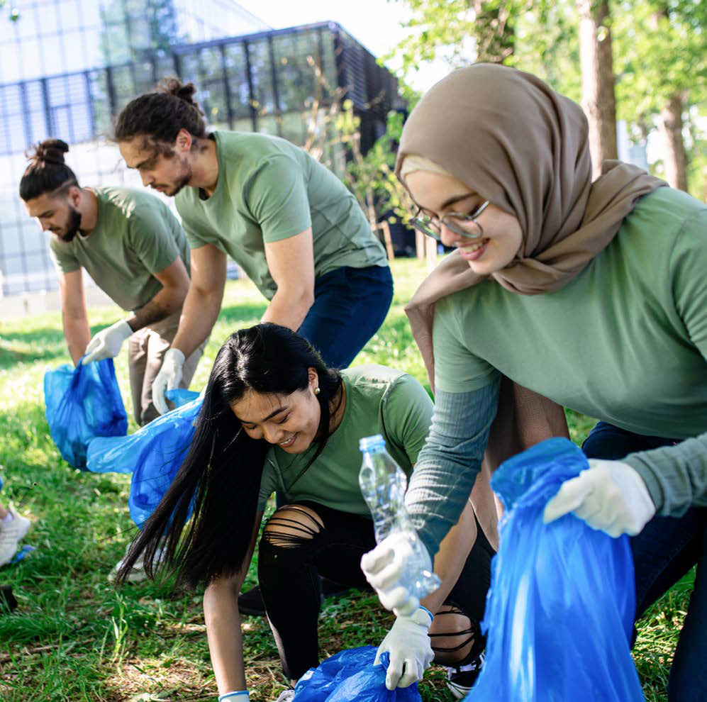 Group of colleagues picking up litter