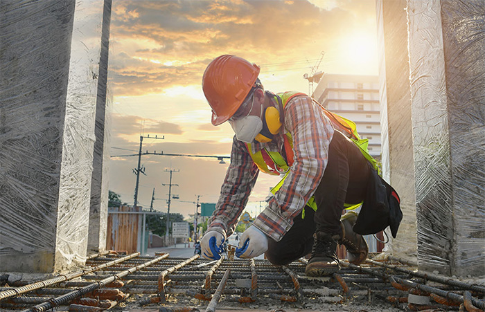 Construction worker working with rebar on construction site
