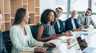 Five businesspeople in a lively boardroom
