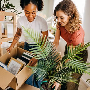 Two women looking at books regarding mortgages
