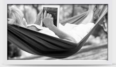 Image of woman in hammock with a tablet