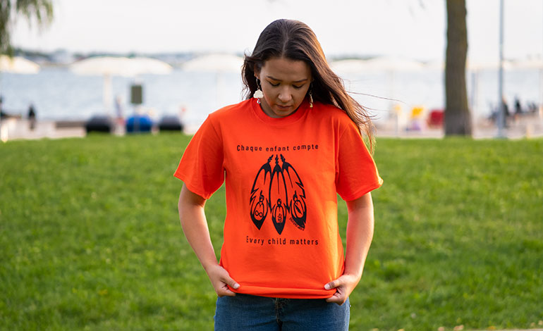 Woman wearing an orange shirt to commemorate National Day of Truth and Reconciliation