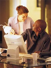Couple in their home office sitting in front of a computer